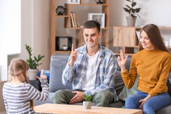 Deaf mute family using sign language at home�