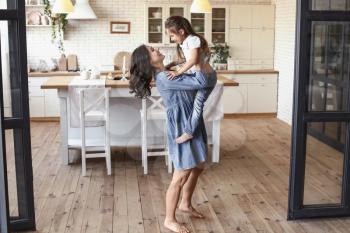 Happy mother and daughter having fun at home�