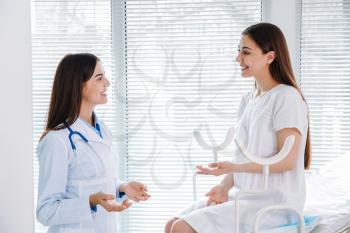 Female gynecologist working with patient in clinic�