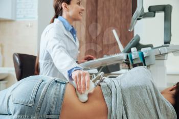 Woman undergoing ultrasound scan in clinic�