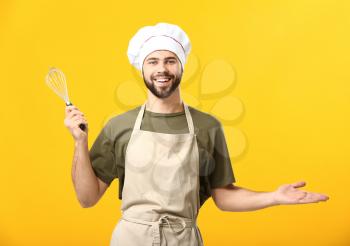 Handsome male chef on color background�
