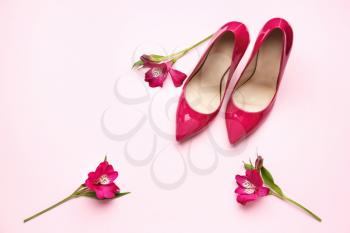 Stylish high heeled shoes on color background�