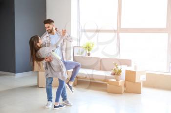 Young couple dancing in their new house�