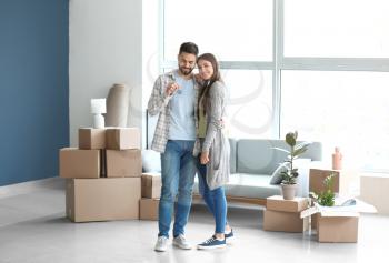 Young couple with keys in their new house�