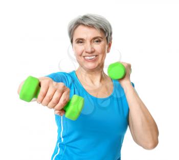 Sporty mature woman with dumbbells on white background�
