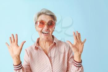 Happy mature woman on color background�