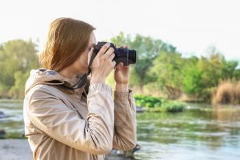 Female tourist taking photo of river�