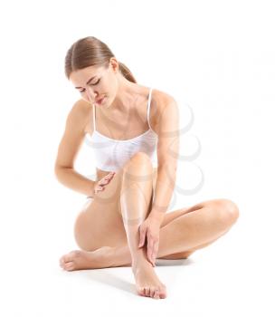 Beautiful young woman with smooth skin after depilation on white background�