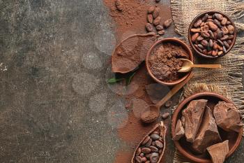 Composition with cocoa powder and chocolate on dark background�