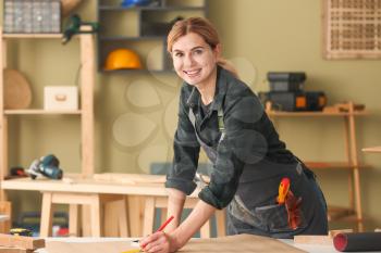 Portrait of female carpenter in workshop�