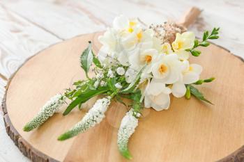Beautiful bouquet with freesia flowers on wooden board�