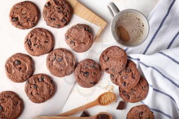Tasty chocolate cookies and cup of coffee on light table�