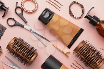 Set of hairdresser tools and accessories on color background�