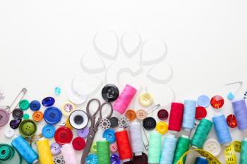 Set of sewing threads and accessories on white background�