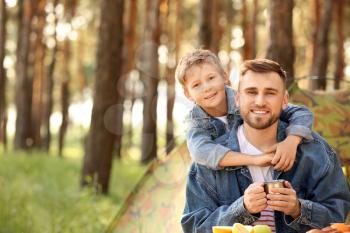 Father and his little son spending weekend in forest�