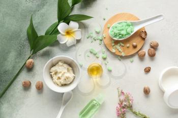 Shea butter with cosmetic products on light background�