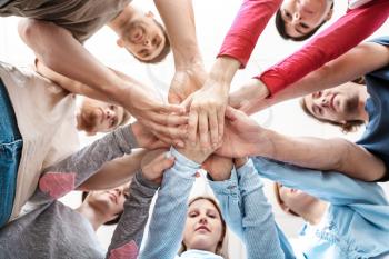 People putting hands together at group therapy session, bottom view�