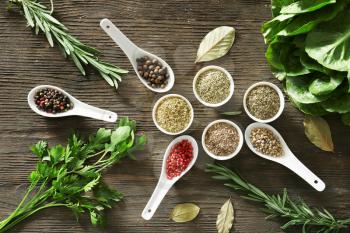 Different herbs and spices on wooden background�