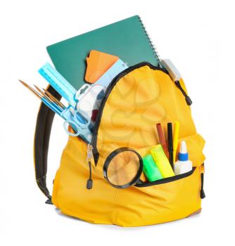 School backpack with stationery on white background�