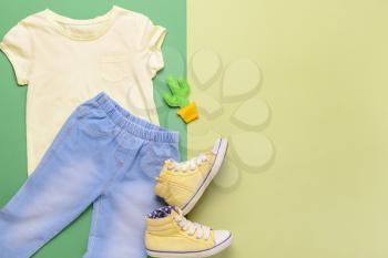 Stylish child look with jeans clothes on color background�