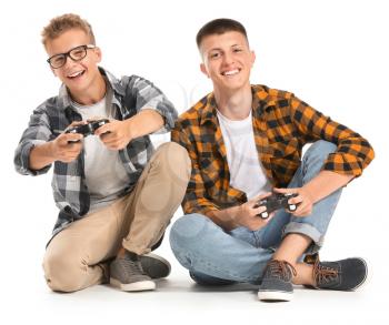 Teenage boys playing video game on white background�