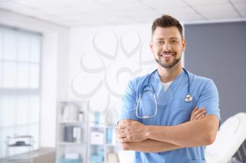 Male nurse with stethoscope in clinic�