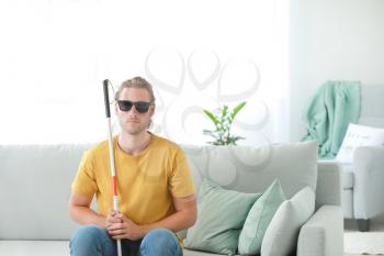 Blind young man at home�