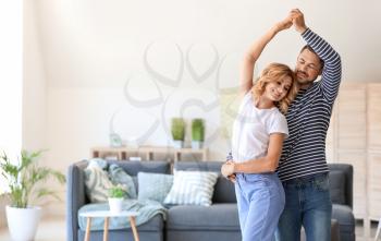 Happy dancing couple at home�