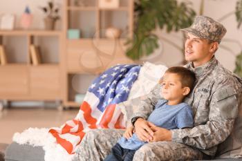 Happy military man with his son at home�