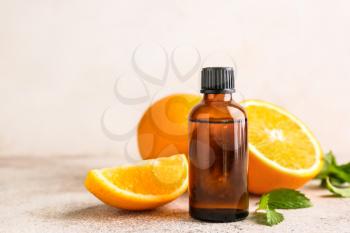 Bottle of citrus essential oil on table�