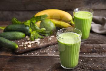 Glasses of healthy smoothie on wooden table�