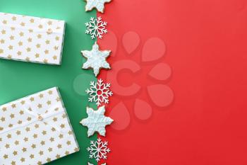 Christmas gifts, decor and cookies on color background�