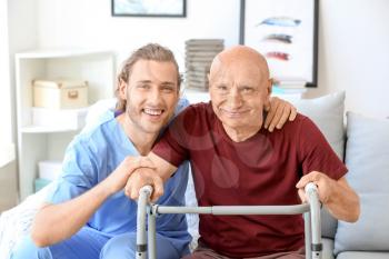 Elderly man with caregiver in nursing home 