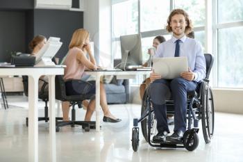 Handicapped young man working in office�