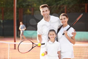 Happy family on tennis court�