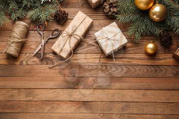 Gift boxes with Christmas decor on wooden background�