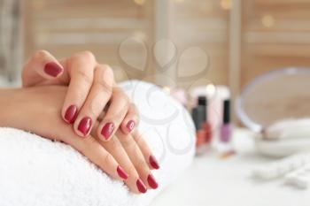 Woman with beautiful manicure in salon�