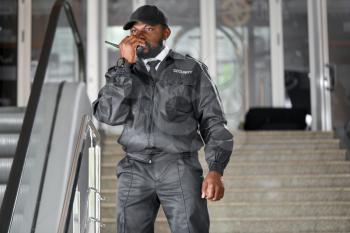 African-American security guard working in building�