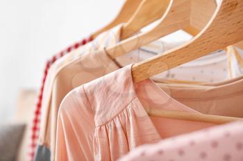 Hangers with stylish clothes, closeup�