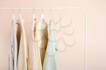 Rack with stylish clothes on light background�