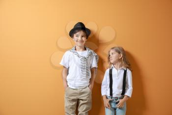 Stylish little children on color background�