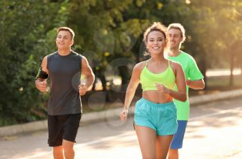 Group of sporty young people running outdoors�