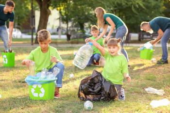 People gathering garbage outdoors. Concept of recycling�