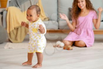 Cute little baby learning to walk at home�