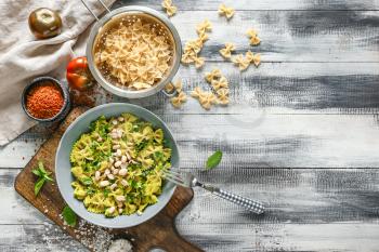 Boiled and dry pasta on wooden table�