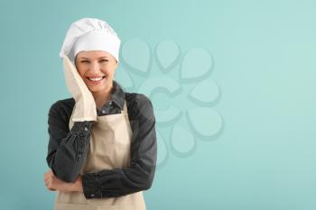 Beautiful female chef on color background�