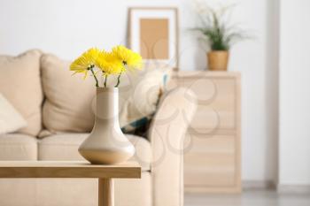 Beautiful chrysanthemum flowers in vase on table in room�