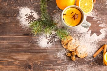Christmas composition with fresh oranges and tea on wooden background�