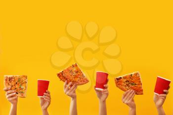 Many hands with pizza and cups for coffee on color background�
