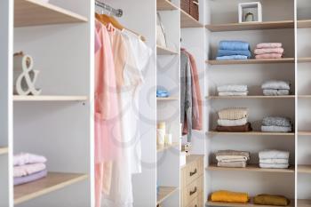 Wardrobe with stacks of clean clothes�